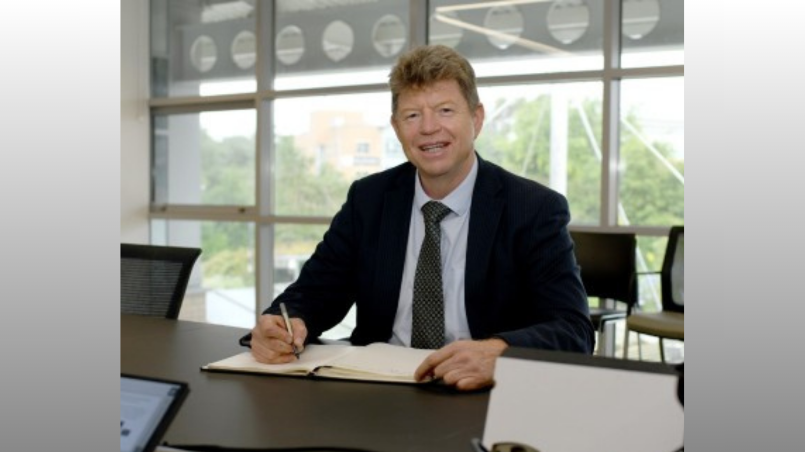 Professor Bob Doherty, sat behind desk